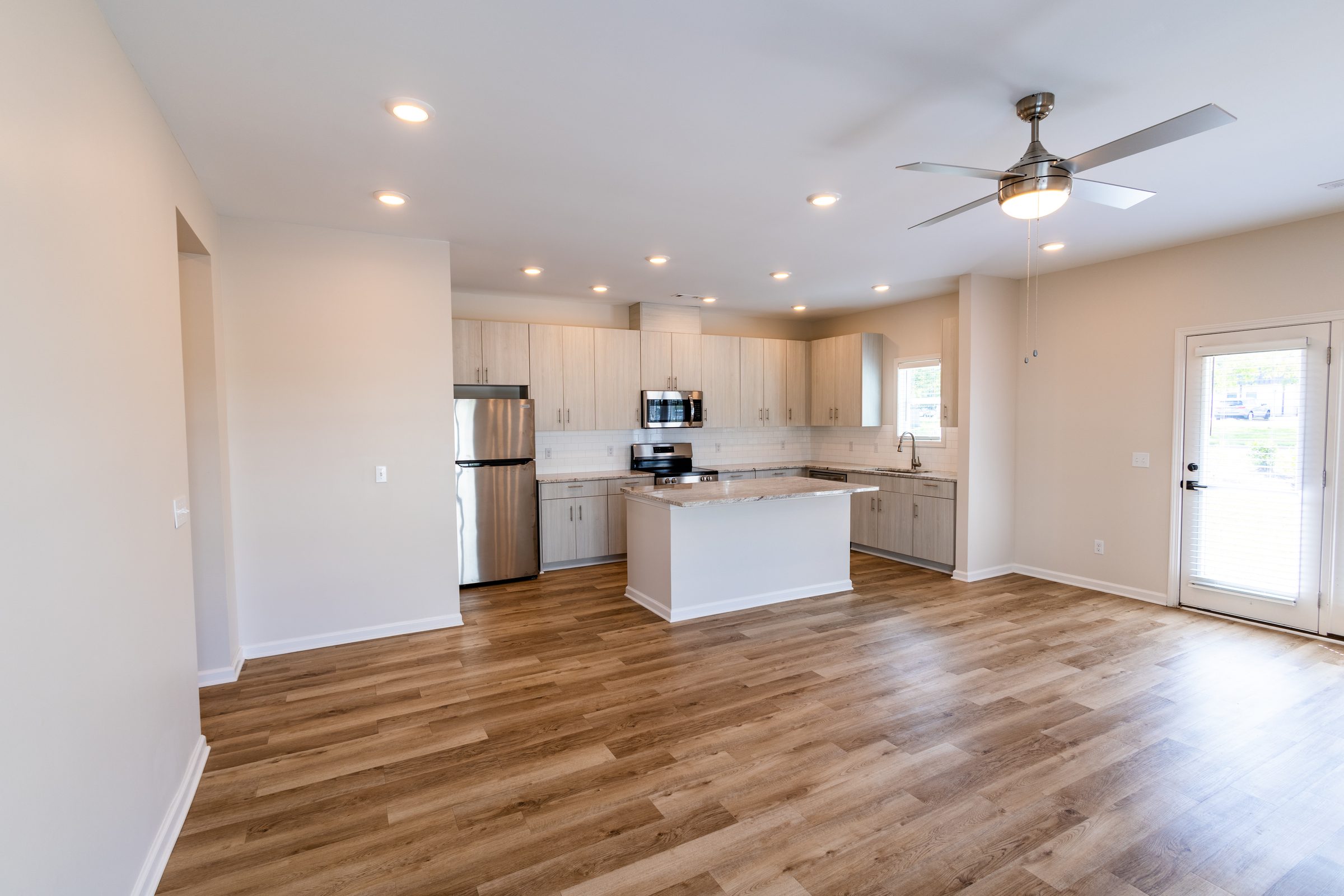 Everstead kitchen with granite island and stainless appliances